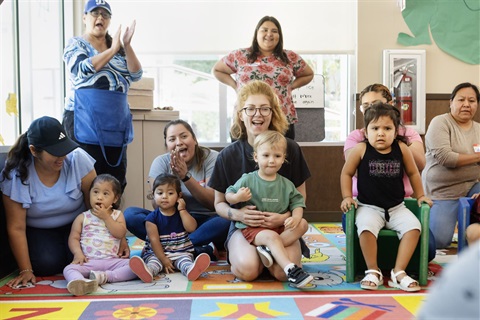 Group of parents holding their children and cheering