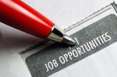 Pen pointing to news article that reads Job Opportunities